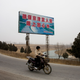 A sign says, “To ensure that the people of Beijing, Tianjin, and Hebei can drink safe water.”